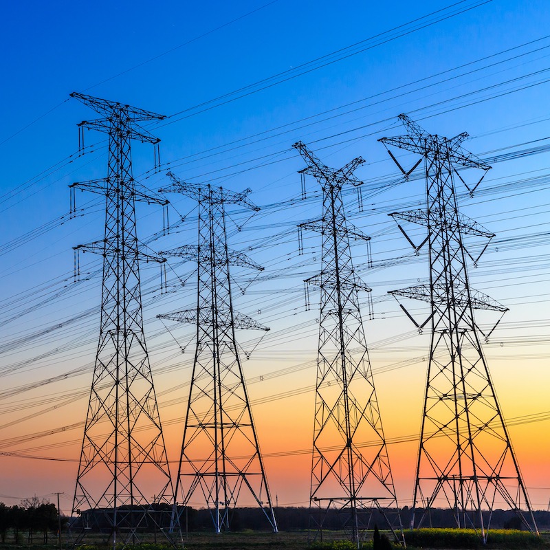 Transmission towers and power lines at dusk.